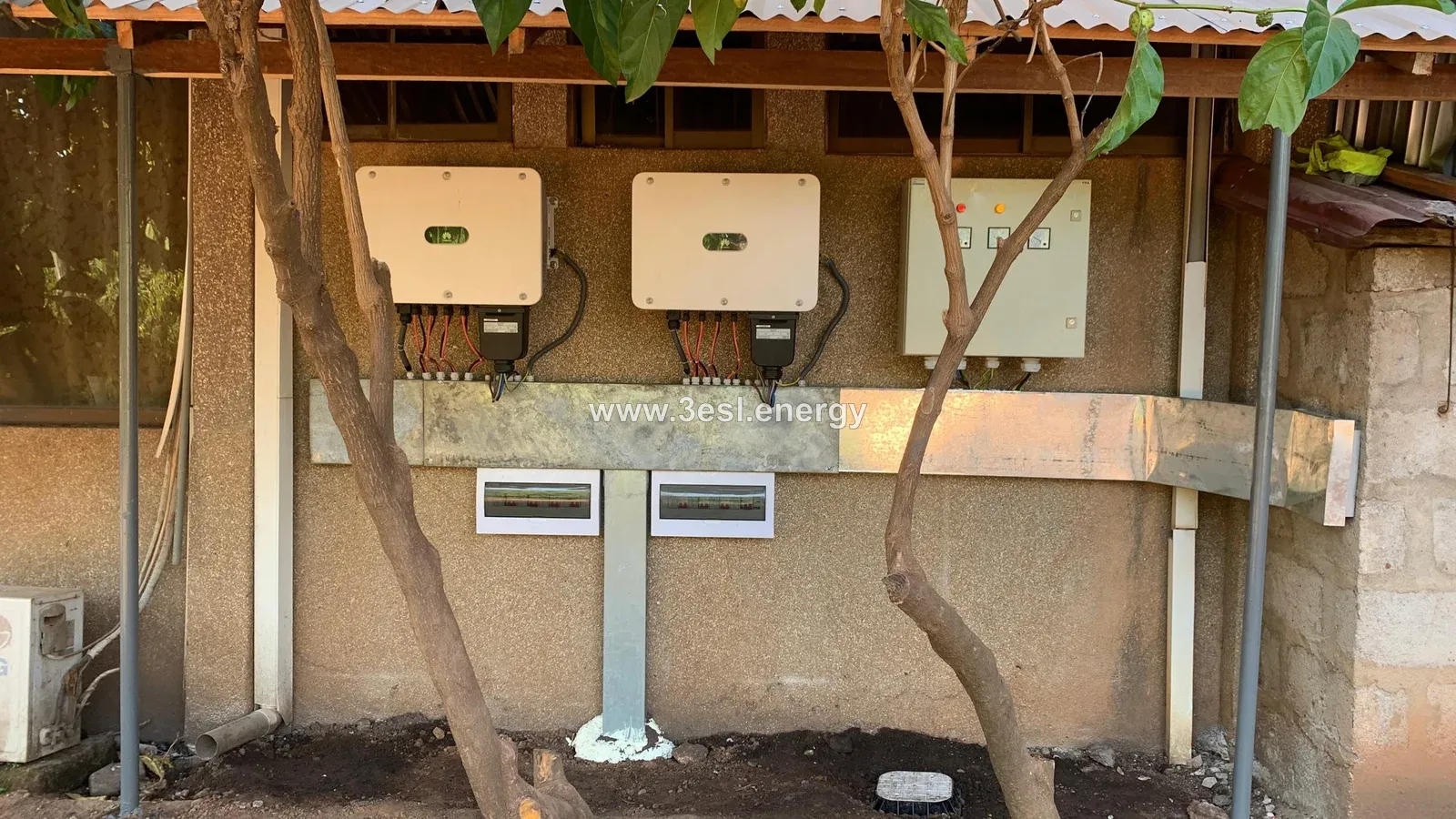 Two wall-mounted solar inverters and associated electrical protection equipment.