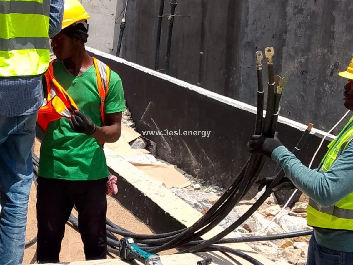 Installation team preparing heavy electrical cables and cable lugs.