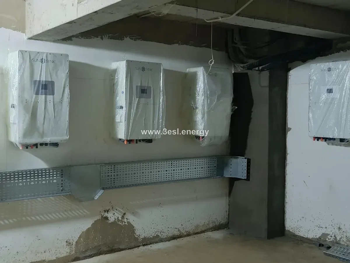 Wall-mounted Sunsynk inverters with protective wrapping above a cable tray.