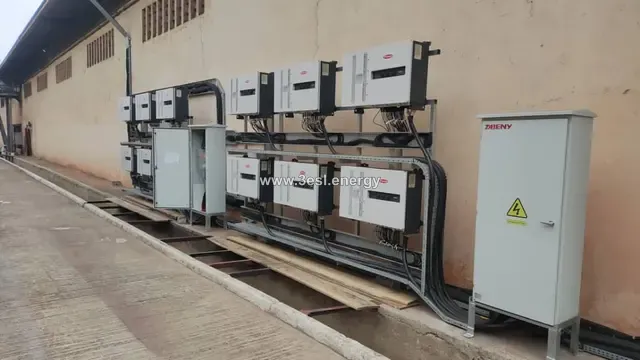 An industrial rooftop array with a timber maintenance walkway running between the module rows.