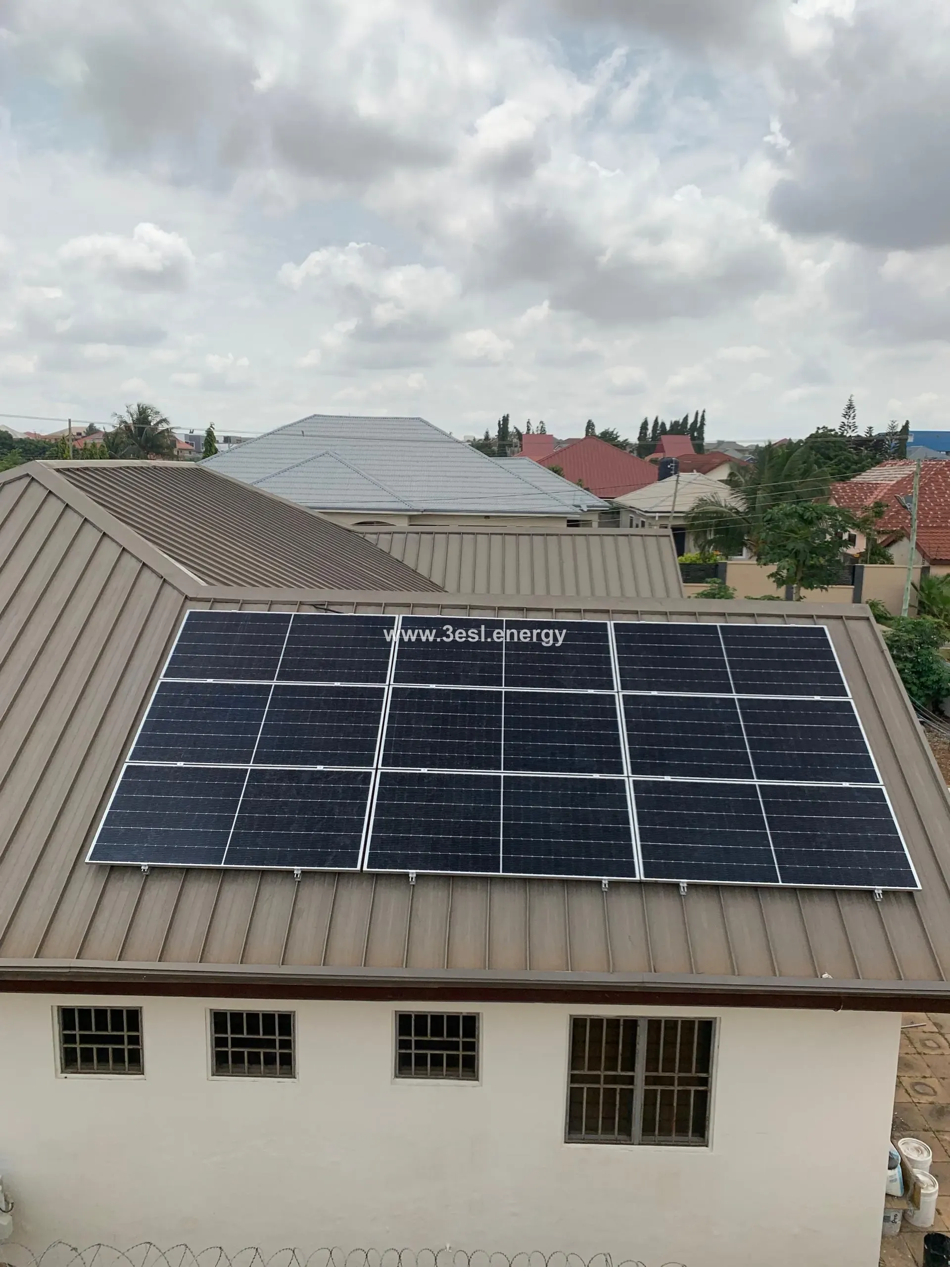 Solar modules mounted in a neat block on a brown standing-seam metal roof.