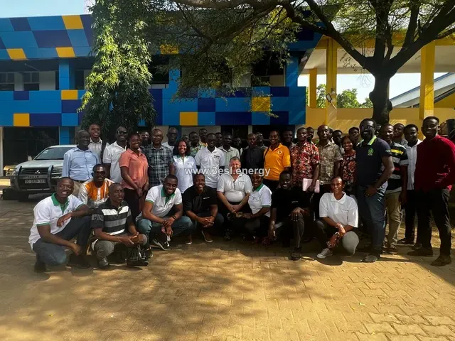 A large cohort of trainee installers photographed together outside the training venue.